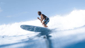 Surfers enjoying the Midigama surf, skillfully navigating the waves against a scenic Sri Lankan backdrop