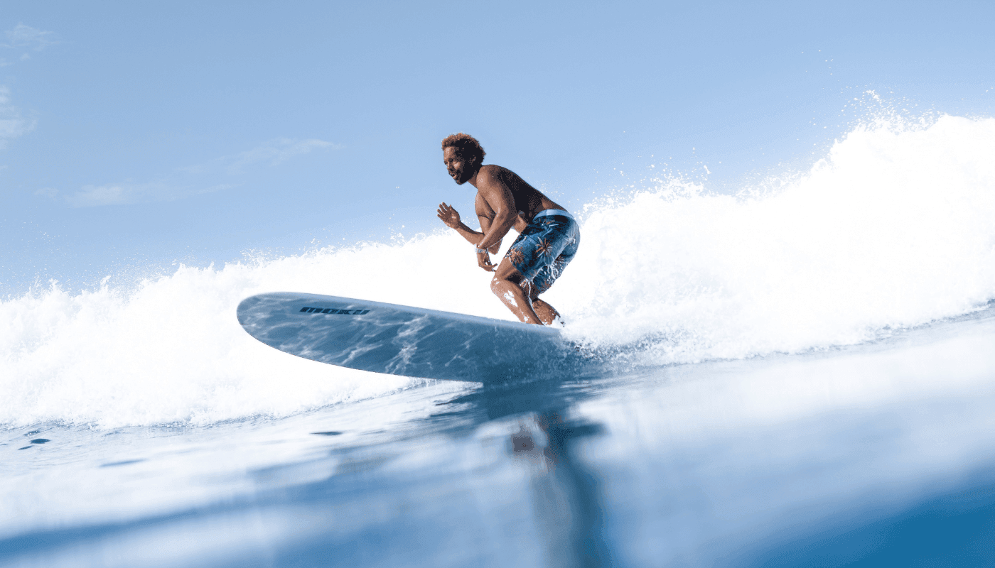 Surfers enjoying the Midigama surf, skillfully navigating the waves against a scenic Sri Lankan backdrop