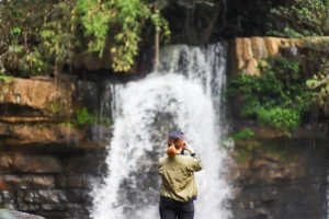 rear view woman photographing waterfall 1