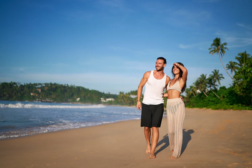 happy couple strolls sandy beach tropical destination romantic walk shoreline embrace leisure min