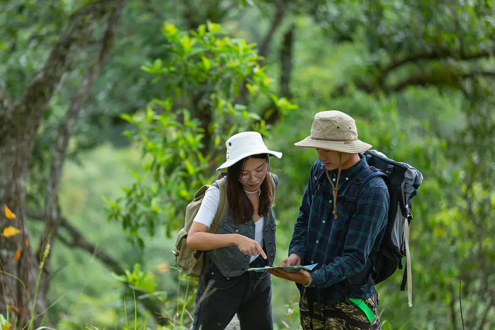 happy hiker walks through jungle with backpack min